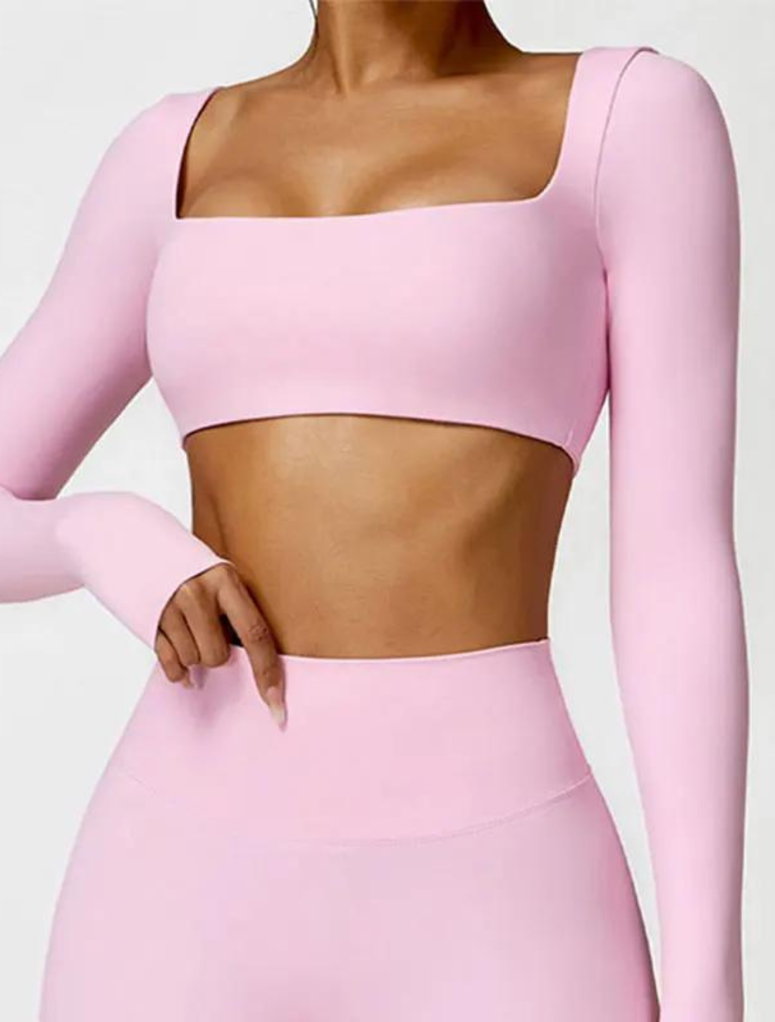 Top fitness feminino rosa, composto por top de manga longa com decote quadrado e calça de cintura alta. Ajuste perfeito e tecido elástico para conforto e estilo.